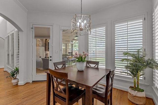 2248 Forest Hollow Park, Dallas, TX 75228 - dining area with a chandelier, arched walkways, light wood-style floors, and crown molding