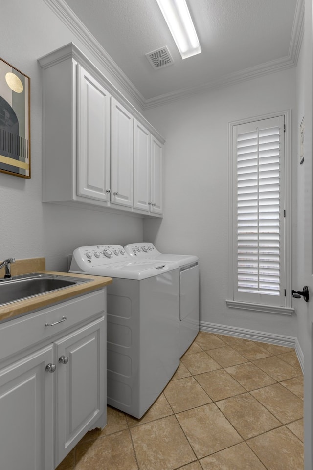 2248 Forest Hollow Park, Dallas, TX 75228 - laundry room with independent washer and dryer, cabinet space, ornamental molding, and light tile patterned flooring