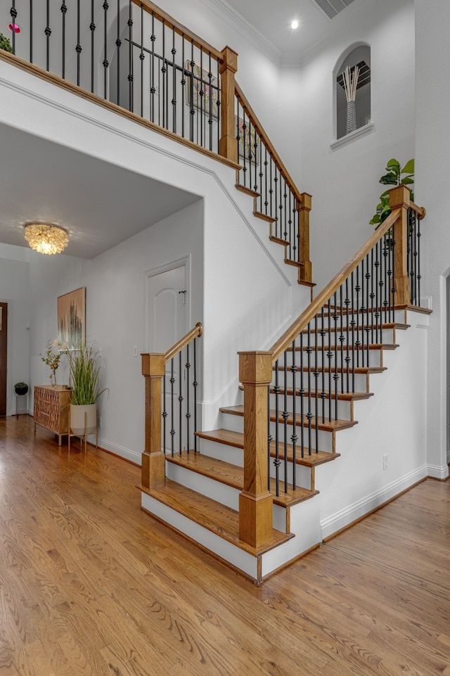 2248 Forest Hollow Park, Dallas, TX 75228 - staircase with wood finished floors, a towering ceiling, and crown molding