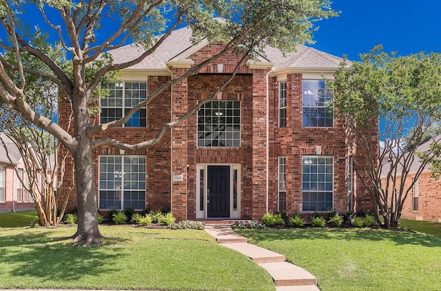 2505 Hunters Run Dr, Plano, TX 75025 - traditional-style home featuring brick siding, a front yard, and roof with shingles