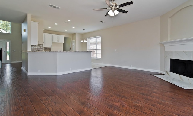 2505 Hunters Run Dr, Plano, TX 75025 - unfurnished living room with a ceiling fan, dark wood-style flooring, recessed lighting, and a premium fireplace