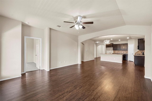 3217 Beutel Rd, Lorena, TX 76655 - unfurnished living room with arched walkways, a ceiling fan, dark wood-style flooring, vaulted ceiling, and recessed lighting