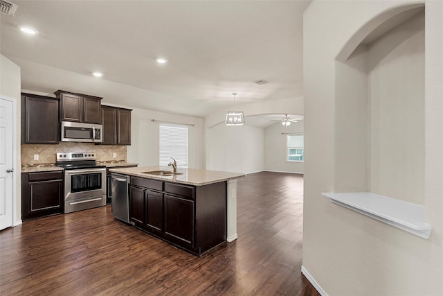 3217 Beutel Rd, Lorena, TX 76655 - kitchen with stainless steel appliances, dark wood-style flooring, backsplash, dark brown cabinets, and light stone counters