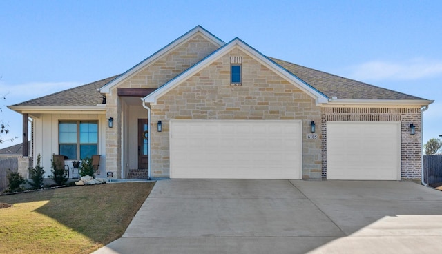 6105 Parma Ln, Temple, TX 76502 - ranch-style house with stone siding, a garage, concrete driveway, a front yard, and roof with shingles
