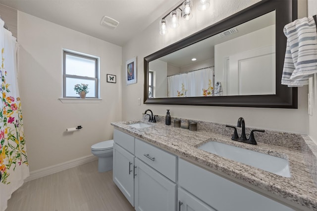 6105 Parma Ln, Temple, TX 76502 - bathroom with double vanity and a shower with shower curtain