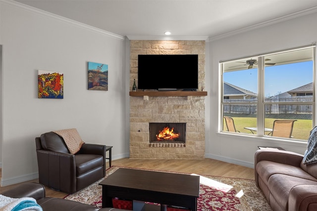 6105 Parma Ln, Temple, TX 76502 - living area featuring wood finished floors, a stone fireplace, crown molding, and recessed lighting