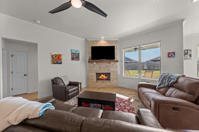 6105 Parma Ln, Temple, TX 76502 - living room with crown molding, a ceiling fan, wood finished floors, and a stone fireplace