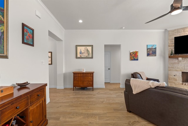 6105 Parma Ln, Temple, TX 76502 - living room with a fireplace, ornamental molding, a ceiling fan, light wood-style floors, and recessed lighting