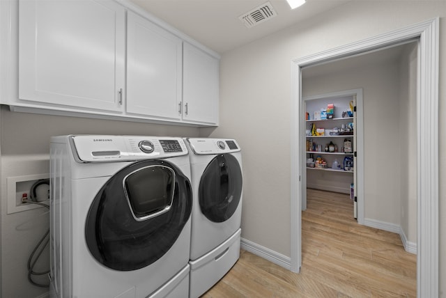 6105 Parma Ln, Temple, TX 76502 - washroom featuring cabinet space, washer and clothes dryer, and light wood-style flooring