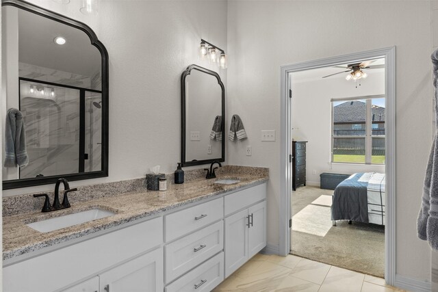 6105 Parma Ln, Temple, TX 76502 - bathroom featuring double vanity, ceiling fan, a shower stall, and ensuite bath