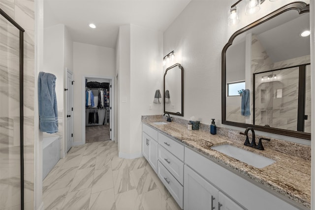 6105 Parma Ln, Temple, TX 76502 - bathroom featuring marble look tiles, a shower stall, a walk in closet, double vanity, and recessed lighting