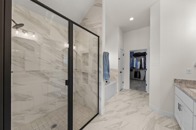 6105 Parma Ln, Temple, TX 76502 - bathroom featuring marble finish flooring, vanity, a shower stall, a garden tub, and a walk in closet