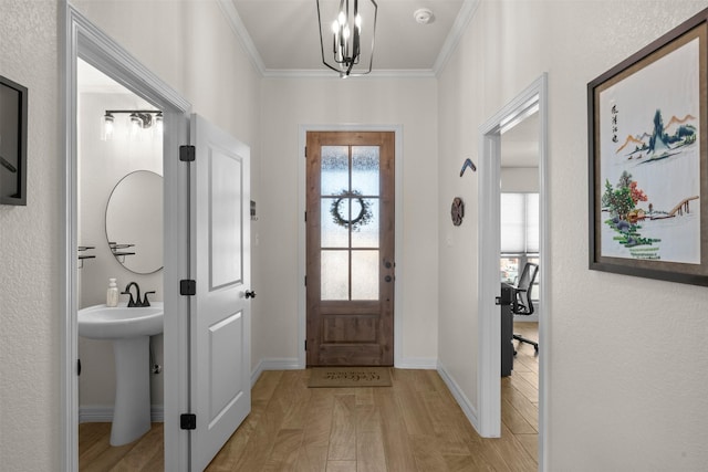 6105 Parma Ln, Temple, TX 76502 - entryway with light wood finished floors, ornamental molding, and a chandelier