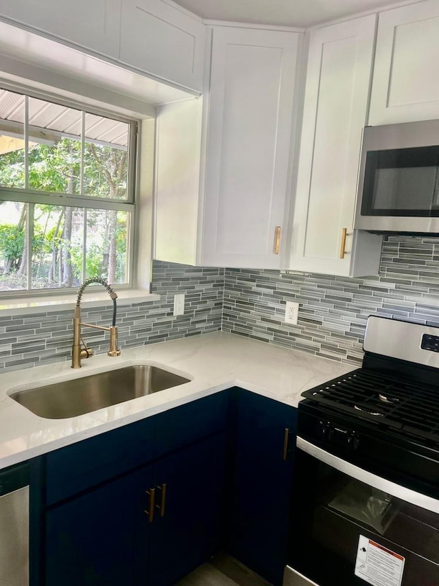 3633 Flamingo Way, Mesquite, TX 75150 - kitchen with appliances with stainless steel finishes, backsplash, white cabinets, and light stone countertops