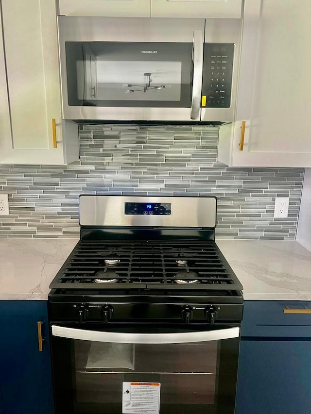 3633 Flamingo Way, Mesquite, TX 75150 - kitchen view of stainless steel appliances, light stone countertops, backsplash, and white cabinetry