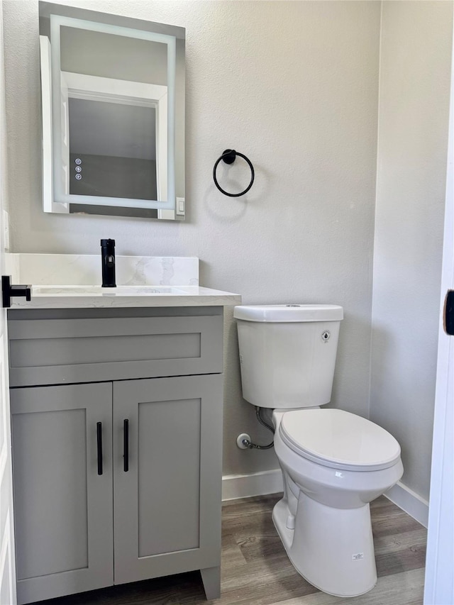 3633 Flamingo Way, Mesquite, TX 75150 - half bathroom featuring vanity and wood finished floors
