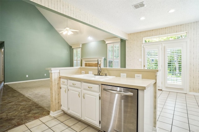 448 Shade Tree Cir, Hurst, TX 76054 - kitchen with stainless steel dishwasher, white cabinetry, light countertops, an island with sink, and ceiling fan