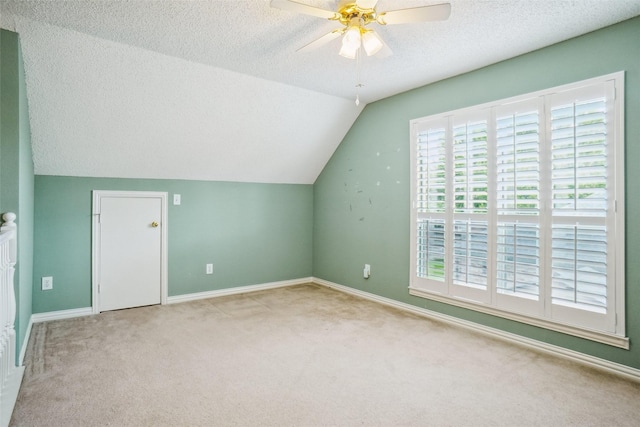 448 Shade Tree Cir, Hurst, TX 76054 - bonus room featuring a textured ceiling, carpet floors, lofted ceiling, and a ceiling fan