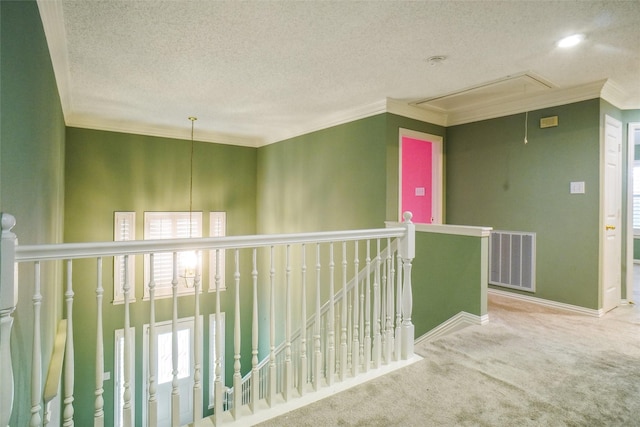448 Shade Tree Cir, Hurst, TX 76054 - hall with attic access, carpet flooring, an upstairs landing, a textured ceiling, and crown molding