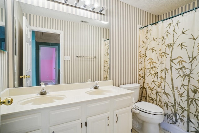 448 Shade Tree Cir, Hurst, TX 76054 - bathroom with wallpapered walls, double vanity, a textured ceiling, and a shower with shower curtain