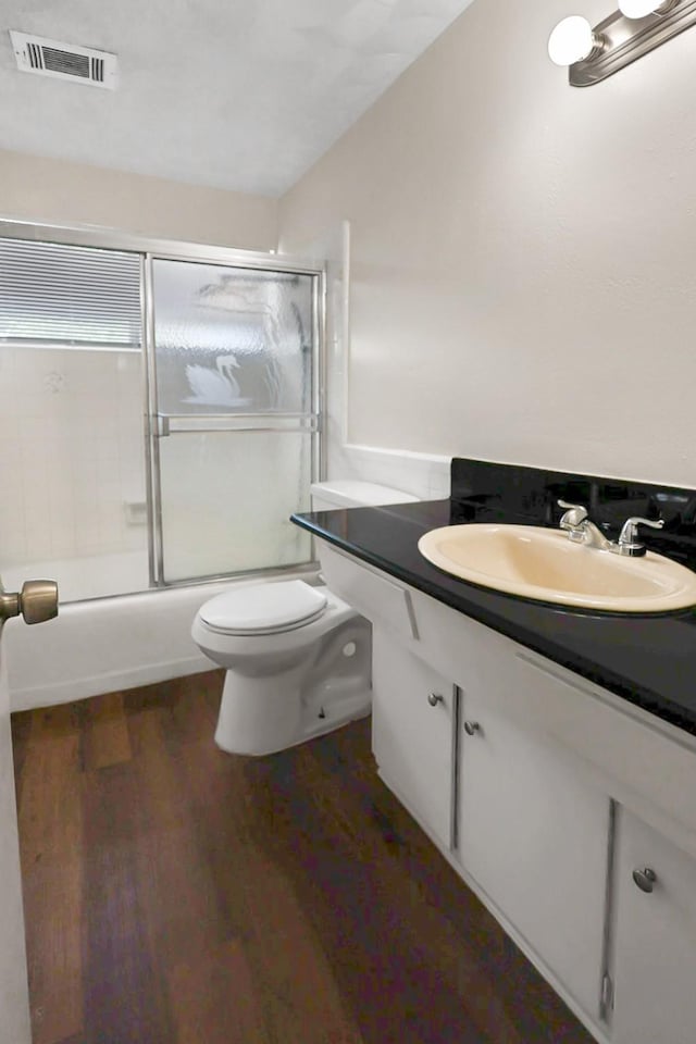 2023 Windchime Dr, Dallas, TX 75224 - bathroom featuring vanity, enclosed tub / shower combo, and wood finished floors