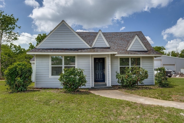 606 E 12th St, Bonham, TX 75418 - view of front facade with a front yard and a shingled roof