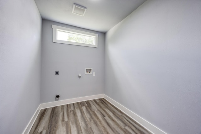 606 E 12th St, Bonham, TX 75418 - laundry room with hookup for an electric dryer, washer hookup, wood finished floors, and hookup for a gas dryer