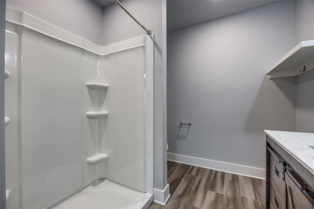 606 E 12th St, Bonham, TX 75418 - bathroom with a shower stall, wood finished floors, and vanity