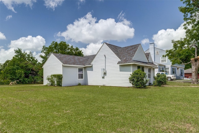 606 E 12th St, Bonham, TX 75418 - view of side of home with a lawn and a shingled roof