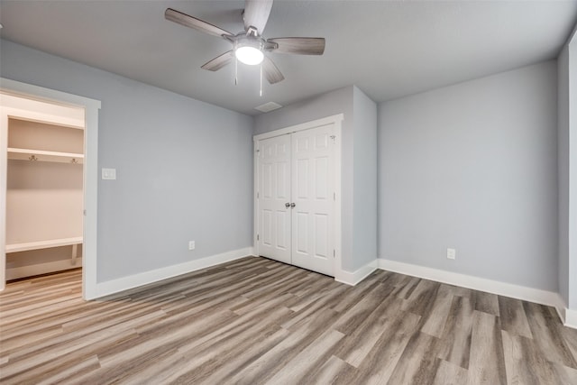 606 E 12th St, Bonham, TX 75418 - unfurnished bedroom with a closet, wood finished floors, and ceiling fan
