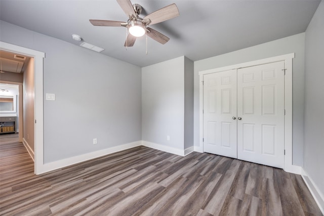 606 E 12th St, Bonham, TX 75418 - unfurnished bedroom featuring attic access, wood finished floors, and a closet