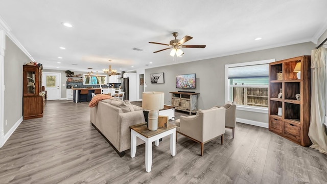 307 Bryan St, Weatherford, TX 76086 - living area featuring ornamental molding, a chandelier, recessed lighting, light wood-type flooring, and a ceiling fan