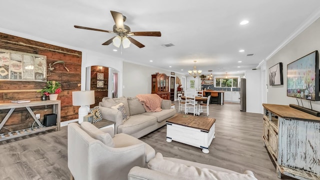 307 Bryan St, Weatherford, TX 76086 - living area featuring arched walkways, a ceiling fan, a chandelier, light wood-style floors, and recessed lighting