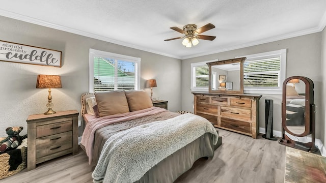 307 Bryan St, Weatherford, TX 76086 - bedroom featuring multiple windows, light wood-style flooring, ornamental molding, and a ceiling fan