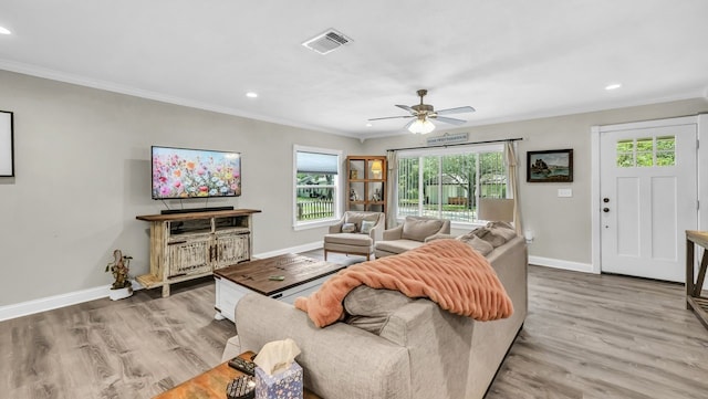 307 Bryan St, Weatherford, TX 76086 - living room with healthy amount of natural light, ornamental molding, wood finished floors, recessed lighting, and a ceiling fan