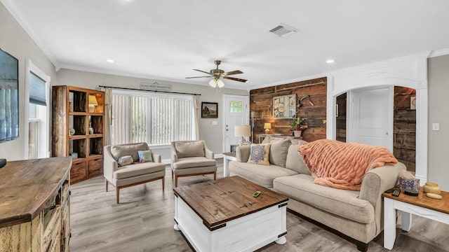 307 Bryan St, Weatherford, TX 76086 - living room with arched walkways, ceiling fan, ornamental molding, light wood-style flooring, and recessed lighting