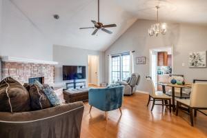 2835 Keller Springs Rd Unit 1102, Carrollton, TX 75006 - living room with ceiling fan, a chandelier, wood finished floors, a brick fireplace, and high vaulted ceiling