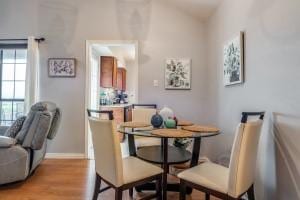 2835 Keller Springs Rd Unit 1102, Carrollton, TX 75006 - dining area featuring healthy amount of natural light, light wood-type flooring, and vaulted ceiling