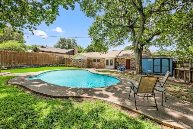 1814 Mary Dr, Euless, TX 76040 - view of swimming pool with french doors, a storage unit, a patio, and a fenced backyard
