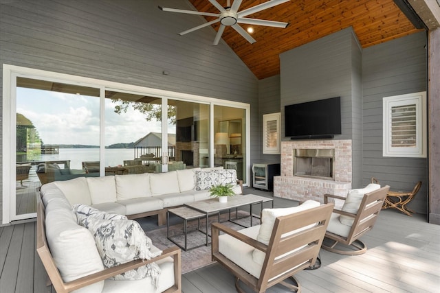 548 Winding Ln, Mount Vernon, TX 75457 - deck with a water view, an outdoor living space with a fireplace, and a ceiling fan