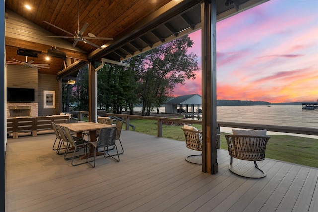 548 Winding Ln, Mount Vernon, TX 75457 - deck at dusk with ceiling fan, outdoor dining space, and a yard