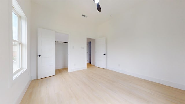 108 Frierson St, Waxahachie, TX 75165 - unfurnished bedroom with multiple windows, light wood-type flooring, a spacious closet, and a closet