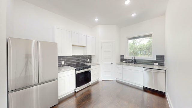 108 Frierson St, Waxahachie, TX 75165 - kitchen featuring appliances with stainless steel finishes, light stone countertops, tasteful backsplash, dark wood-type flooring, and recessed lighting