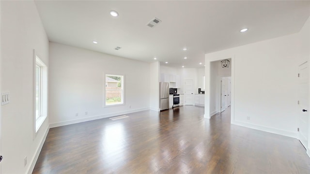 108 Frierson St, Waxahachie, TX 75165 - unfurnished living room featuring recessed lighting and dark wood finished floors