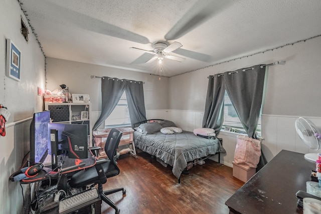 1106 Sunnyvale Dr, Arlington, TX 76010 - bedroom with a textured ceiling, a wainscoted wall, an office area, wood finished floors, and ceiling fan
