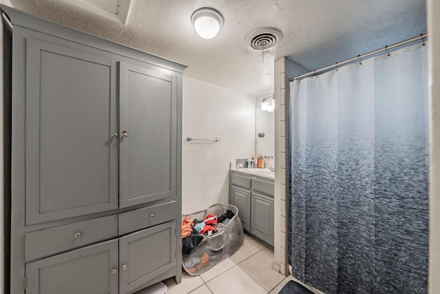 1106 Sunnyvale Dr, Arlington, TX 76010 - full bathroom with tile patterned floors, vanity, a textured ceiling, and a shower with curtain