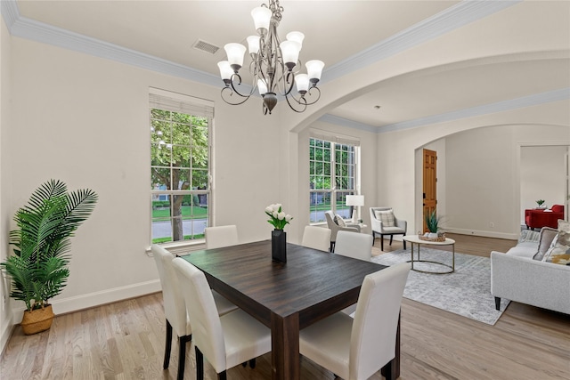 931 N Birdsong Dr, Allen, TX 75013 - dining room with arched walkways, a chandelier, light wood-type flooring, and crown molding