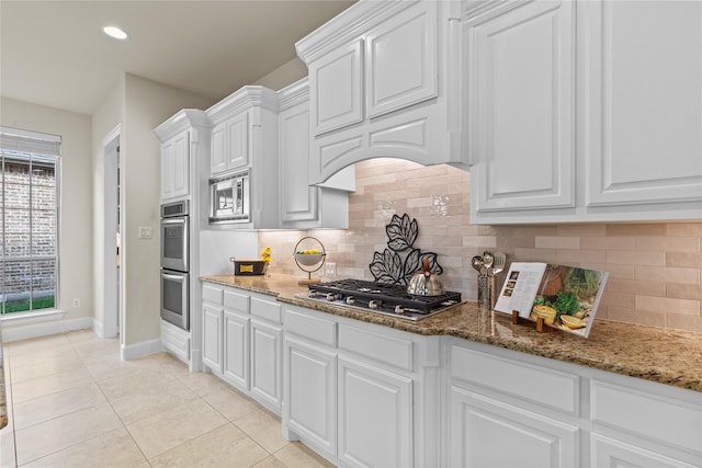 931 N Birdsong Dr, Allen, TX 75013 - kitchen featuring stainless steel appliances, white cabinetry, backsplash, light tile patterned floors, and stone countertops