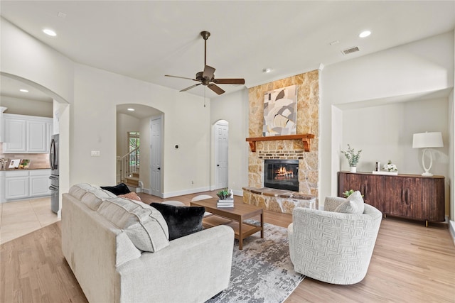 931 N Birdsong Dr, Allen, TX 75013 - living area with arched walkways, light wood finished floors, stairs, a ceiling fan, and recessed lighting