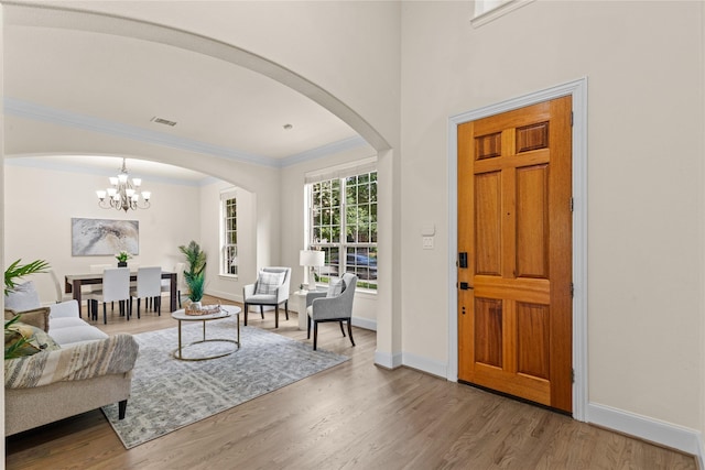 931 N Birdsong Dr, Allen, TX 75013 - entryway with arched walkways, crown molding, wood finished floors, and a chandelier
